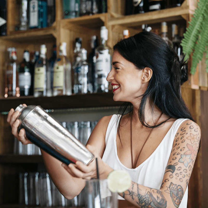 bartender mixing a drink with metal shaker